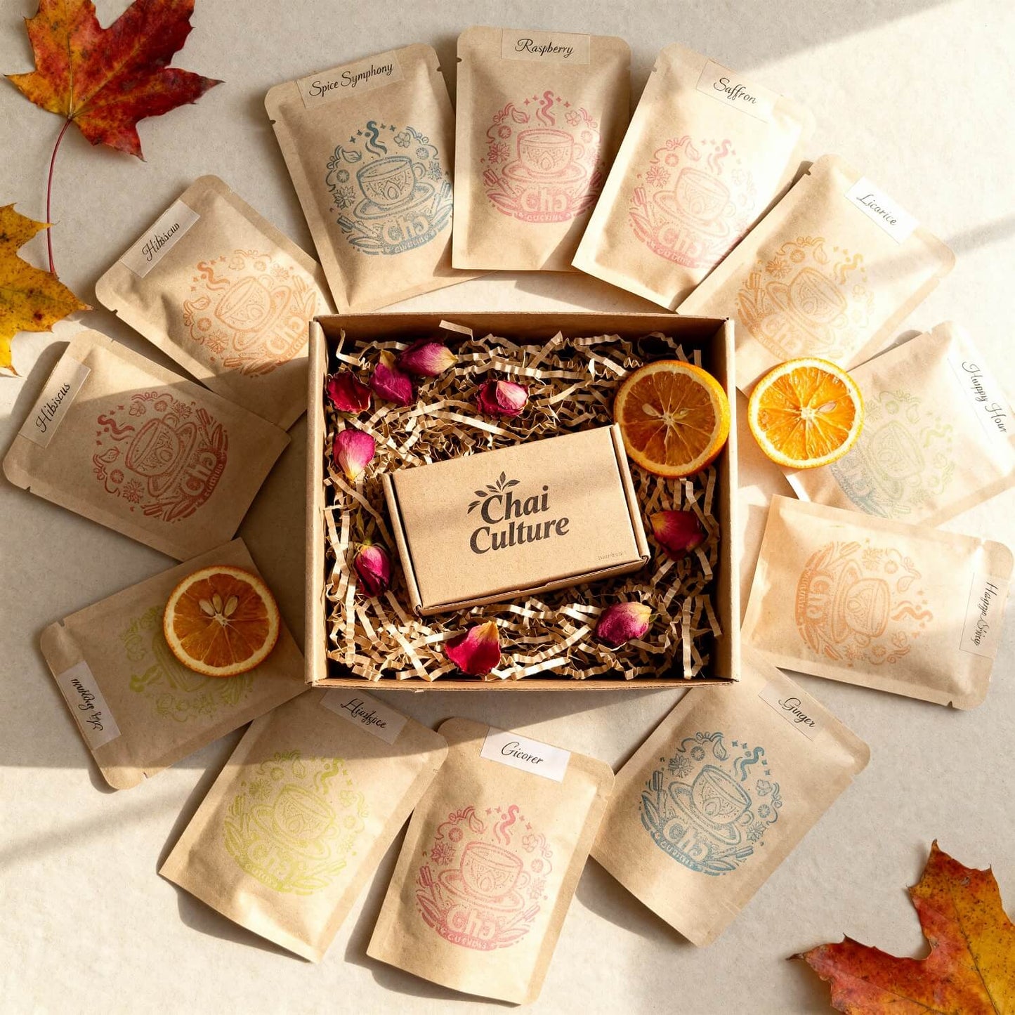 Tea packaging with 'Chai Culture' branding on a light background with autumn leaves.