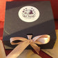 Black gift box with a gold ribbon and 'Chai Culture' label on a red background
