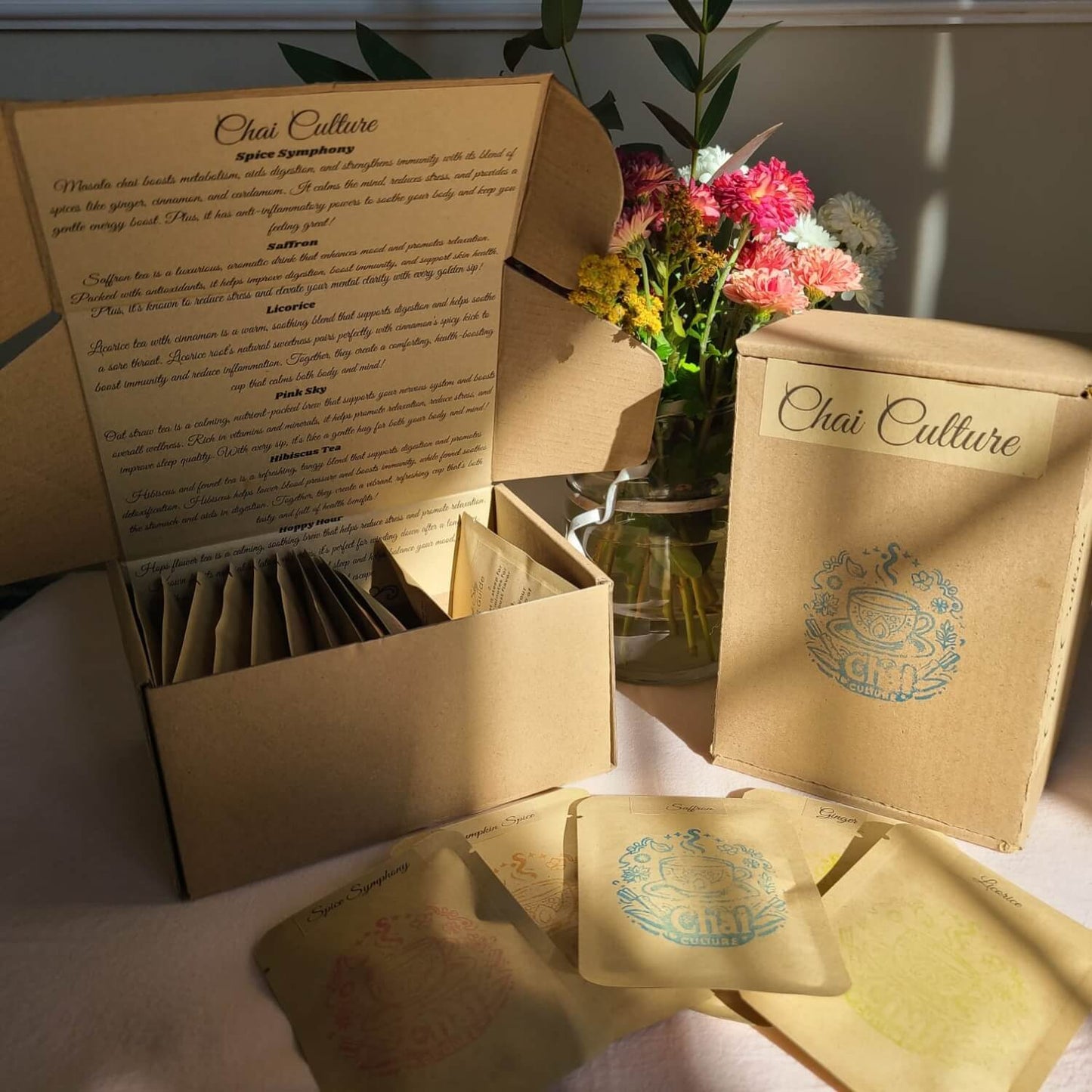 Chai Culture tea packaging with open box and tea bags on a table.